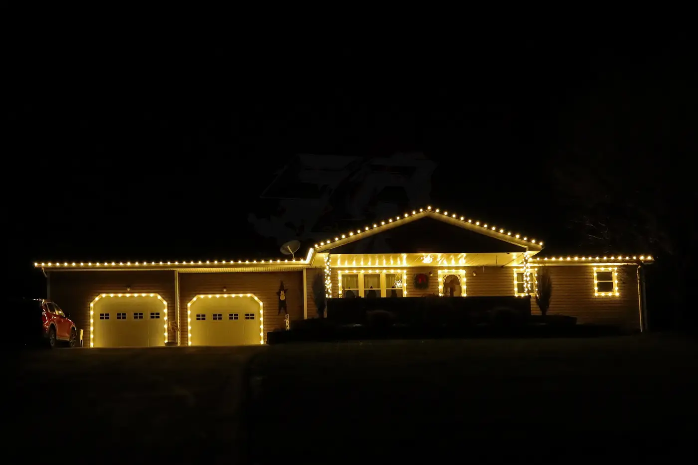 Home with traditional warm-white Christmas lights installed by Thraxel