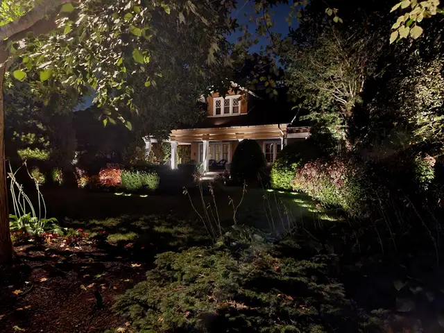Residential permanent roofline lighting install at night