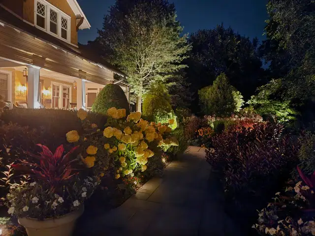 Home exterior lit with color permanent lighting after dark