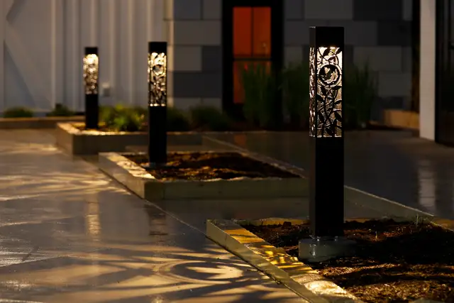 Lighted bollards along a walkway at night