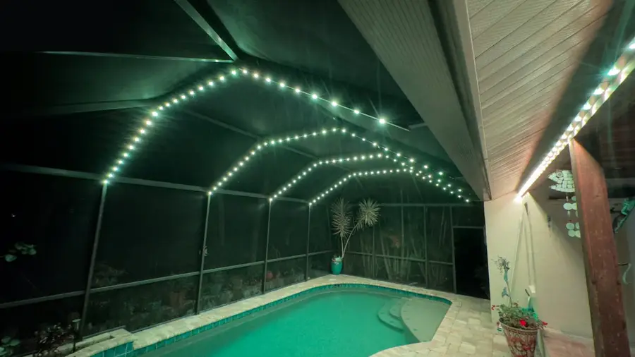 Pool house lit at night with permanent lighting